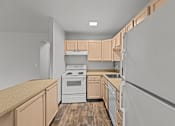 Thumbnail 17 of 41 - A kitchen with wooden cabinets and a white stove top oven