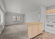 Thumbnail 18 of 41 - A kitchen with a white stove and a window with blinds