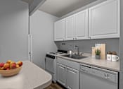 Thumbnail 21 of 41 - A kitchen with a bowl of fruit on the counter
