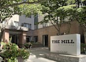 Thumbnail 1 of 41 - The Mill at First Hill is a modern building with a large entrance and a sign at the front.