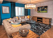 Thumbnail 4 of 41 - A living room with a grey sofa and a wooden coffee table