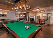 Thumbnail 12 of 41 - A pool table with a green felt cloth and a white cue ball in the middle