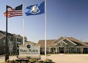 Thumbnail 11 of 22 - The Parc Place Apartment Homes sign is in front of a building.