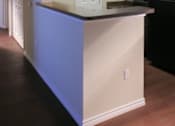 Thumbnail 7 of 22 - A kitchen with a black refrigerator and a white door.