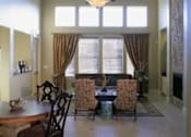 Thumbnail 18 of 22 - A dining room with a table set for four.