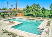 Thumbnail 1 of 22 - A large outdoor swimming pool surrounded by sun loungers.