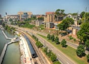 Thumbnail 2 of 17 - A train is on the tracks near a body of water.at Maplehurst Apartments, Tennessee