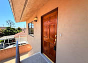 Thumbnail 2 of 12 - A brown door with a black handle is on a tan wall.