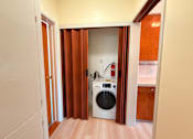 Thumbnail 12 of 12 - A small laundry room with a washer and dryer.