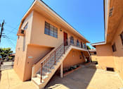 Thumbnail 1 of 12 - A two-story house with a staircase leading to the upper level.