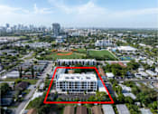 Thumbnail 13 of 21 - A large white building with a red square around it is in the middle of a city.