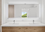 Thumbnail 2 of 21 - A bathroom with two sinks and a large mirror.