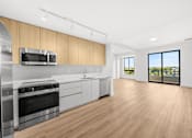 Thumbnail 18 of 21 - A modern kitchen with wooden cabinets and stainless steel appliances.