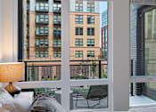 Thumbnail 23 of 34 - a living room with a balcony and a view of the city