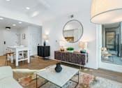 Thumbnail 33 of 34 - a living room with a large mirror and a dining table