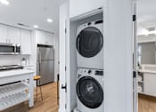Thumbnail 22 of 34 - a white laundry room with a washer and a dryer