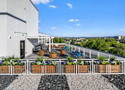Thumbnail 19 of 34 - A patio with a white fence and a black and white striped area in front of it.