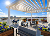 Thumbnail 5 of 34 - A patio with a white pergola and wooden furniture overlooking a cityscape.