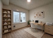 Thumbnail 18 of 30 - A room with a desk, chair, and shelves.
