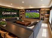 Thumbnail 22 of 30 - A modern bar area with a green wall and a television screen showing a football game.