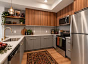 Thumbnail 6 of 51 - A modern kitchen with wooden cabinets and stainless steel appliances.
