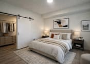 Thumbnail 19 of 30 - A bedroom with a large bed and a wooden floor.