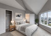 Thumbnail 8 of 14 - A bedroom with a large bed and a view of the city.
