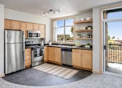 Thumbnail 10 of 14 - A modern kitchen with stainless steel appliances and wooden cabinets.