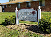 Thumbnail 5 of 12 - A sign that says Laurel Commons stands in front of a brick building.