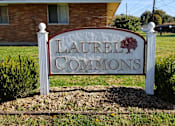 Thumbnail 4 of 12 - A sign that says Laurel Commons stands in a garden.