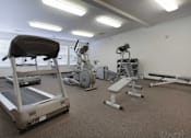 Thumbnail 8 of 37 - A gym with treadmills, exercise bikes, and other equipment.
