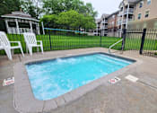 Thumbnail 6 of 37 - A small pool surrounded by a black fence and a white chair.