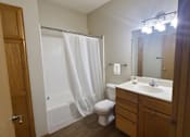 Thumbnail 21 of 37 - A bathroom with a toilet, sink, and shower.