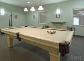 Thumbnail 26 of 37 - A pool table in a room with a light blue wall and a mirror.