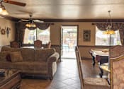 Thumbnail 5 of 38 - A living room with a couch, chairs, and a table.
