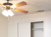 Thumbnail 11 of 38 - A room with a ceiling fan and two doors.