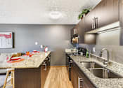Thumbnail 5 of 15 - A kitchen with a counter and a sink.