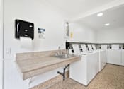 Thumbnail 55 of 57 - a kitchen with a sink and a counter and a washing machine