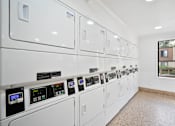 Thumbnail 57 of 57 - a white utility room with white appliances and a window