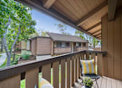 Thumbnail 13 of 57 - a balcony with two chairs and a house in the background