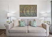 Thumbnail 20 of 57 - a living room with a couch and a painting on the wall