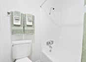 Thumbnail 34 of 57 - a bathroom with a shower and a toilet and towels