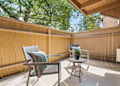 Thumbnail 26 of 57 - a patio with two chairs and a table on a porch
