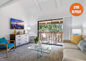 Thumbnail 1 of 57 - A living room with a blue chair and a glass coffee table.