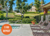 Thumbnail 1 of 41 - a swimming pool with two lounge chairs in front of a house