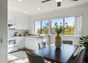Thumbnail 5 of 35 - an open kitchen and dining room with a table and chairs