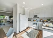 Thumbnail 6 of 35 - a white kitchen with white appliances and white cabinets