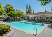 Thumbnail 13 of 38 - a swimming pool with a building in the background