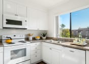 Thumbnail 4 of 35 - a kitchen with white appliances and a window