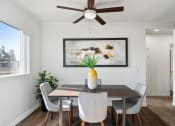 Thumbnail 2 of 35 - a dining room with a table and chairs and a ceiling fan